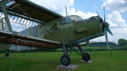 Airplane on field against sky