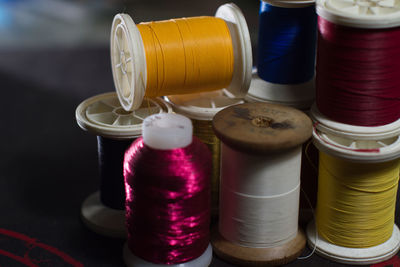 Close-up of multi colored sewing threads on table