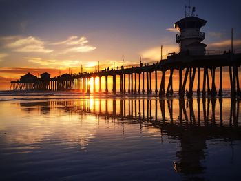 Pier on sea at sunset