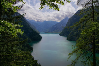 Scenic view of lake amidst mountains against sky