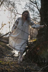 Close up barefoot woman wearing ukrainian folk chemise in forest portrait picture