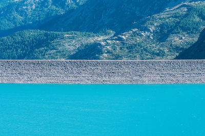 Artificial dam and lake on col de mont cenis, france. hydroelectric power plant