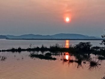 Scenic view of lake against sky during sunset