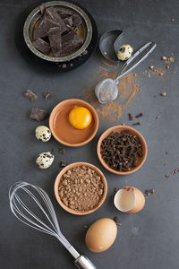 Mix of baking dessert ingredients on dark background, culinary flat lay