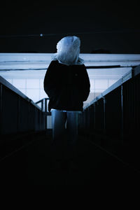 Rear view of man standing in tunnel