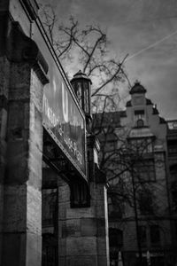 Low angle view of text on building against sky