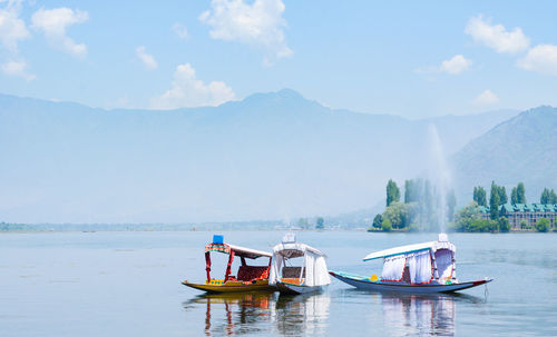 People on boat in sea against sky