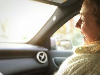 Close-up of woman shouting while sitting in car