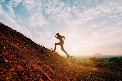 Runners running fitness in woods.athlete running on trail stones in forest.