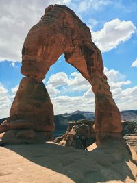 View of rock formation against cloudy sky