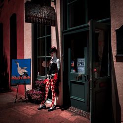 Woman standing by door of building