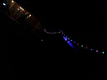 Illuminated lights against sky at night