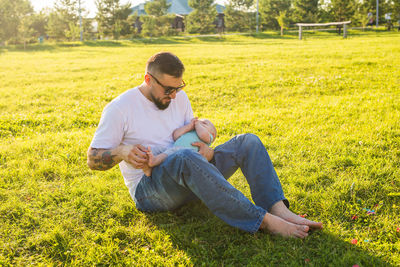 Man sitting on grassy field