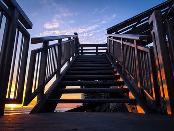 Steps leading towards stairs against sky