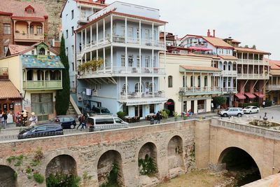 Arch bridge over buildings in city