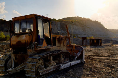 Abandoned truck on field against sky