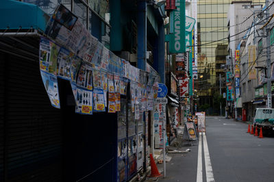 Street light on road amidst buildings in city