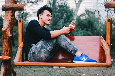 Portrait of young man sitting on seat