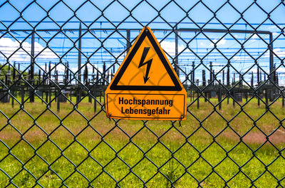Warning sign on chainlink fence
