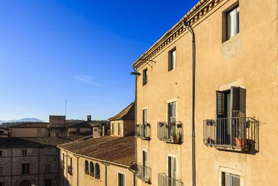Low angle view of residential buildings against blue sky