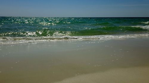 Scenic view of sea against clear blue sky