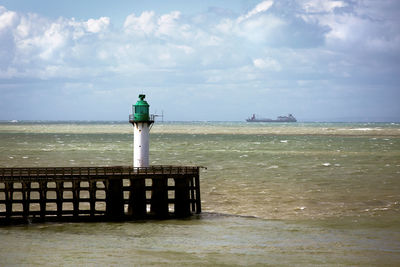 Rear view of lighthouse on sea against sky