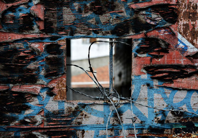 Old rusty window and barbed wire 