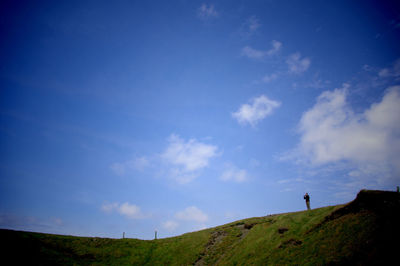 Scenic view of landscape against cloudy sky