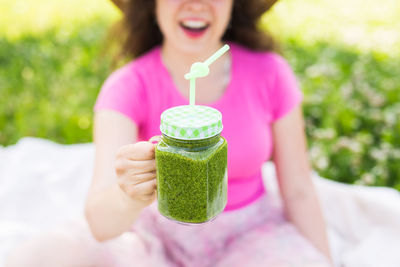 Midsection of woman holding drink