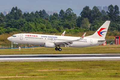 Airplane on airport runway against sky