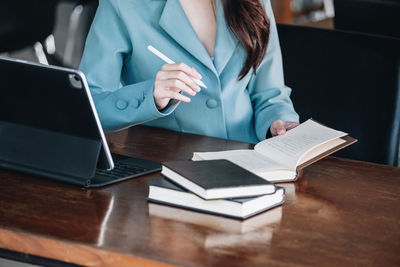 Midsection of doctor using laptop on table