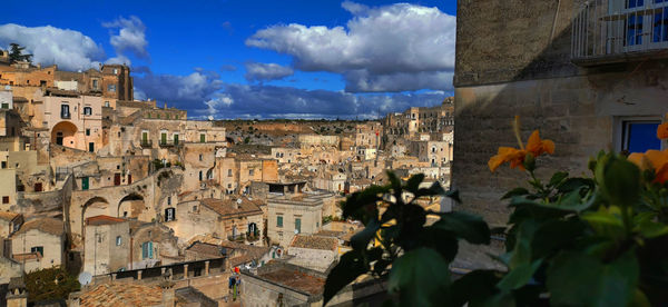 Panoramic view of buildings in town against sky