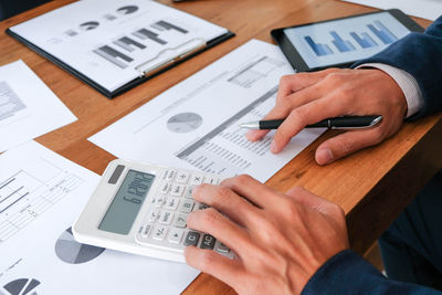 High angle view of man using mobile phone on table