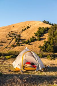 Tent on field against mountain at campsite