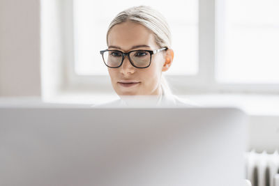 Portrait of businesswoman working with computer