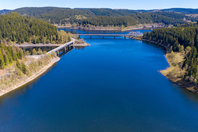 Aerial view of a flight over a reservoir in the harz mountains, a german low mountain range