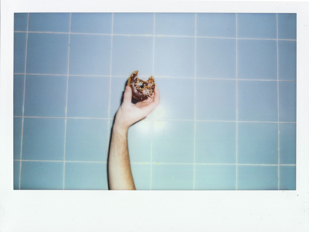 LOW SECTION OF PERSON HOLDING COFFEE BEANS IN BATHROOM