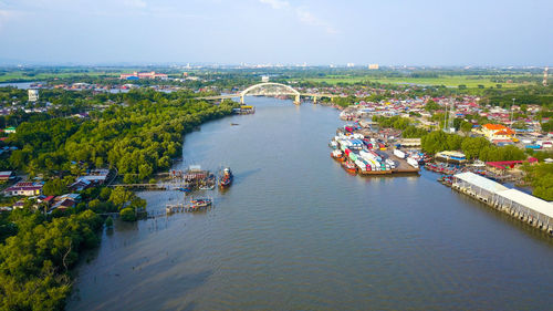 High angle view of river amidst buildings against sky