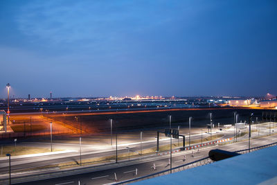 View of illuminated buildings against blue sky