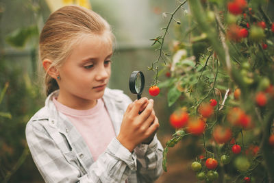 Girl holding fruits and plants