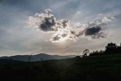 Scenic view of field against sky during sunset