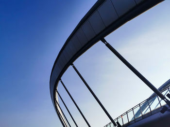 Low angle view of modern building against clear blue sky