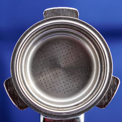 Close-up of portafilter over blue background