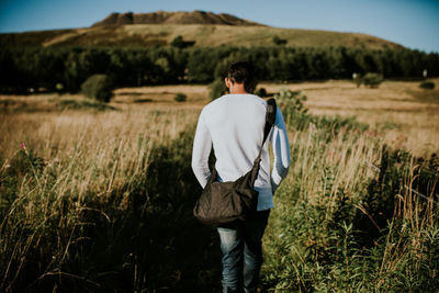 Full length of man walking on field