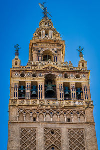 Low angle view of historic building against clear blue sky