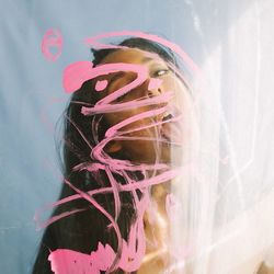 Close-up of young woman swimming underwater