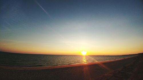 Scenic view of sea against clear sky during sunset