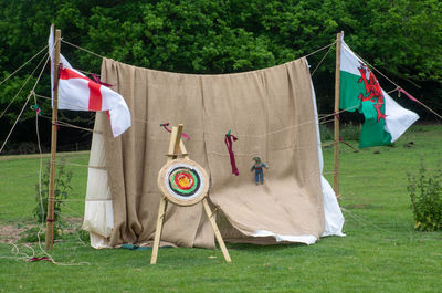 Clothes drying on field against trees