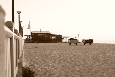 Man on beach against clear sky