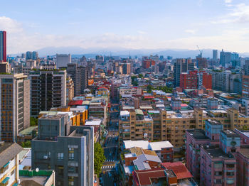 High angle view of modern buildings in city against sky